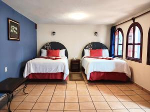 Postel nebo postele na pokoji v ubytování Hotel Jardines Del Carmen