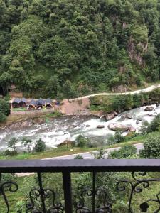 a view from a balcony of a river with tents at Walnut Bungalow in Çamlıhemşin +76 photos