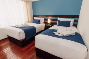 Postel nebo postele na pokoji v ubytování Wayqey Hotel
