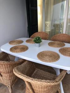 a white table with wicker chairs and a plant on it at Son Parc - Albatros in Son Parc