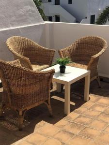 three wicker chairs and a table on a patio at Son Parc - Albatros in Son Parc