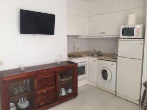 a kitchen with a refrigerator and a washer and dryer at Son Parc - Albatros in Son Parc +1 photo