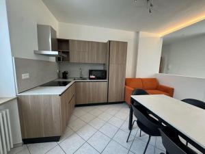 a kitchen and dining room with a table and chairs at Tiramisù Andalo in Andalo