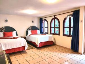 Postel nebo postele na pokoji v ubytování Hotel Jardines Del Carmen