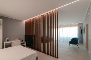a bedroom with a bed and a large wooden wall at King's Rooms in Termoli