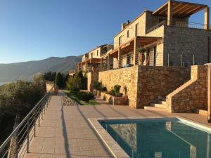 a house with a swimming pool in front of it at VL Luxury Villa in Kiveri