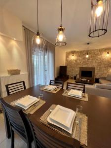 a dining room with a table and a living room at VL Luxury Villa in Kiveri