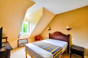 a bedroom with a bed and a desk and a tv at Résidence Les Belles Rives - maeva Home - Appartement 2 pièces 6 personnes - Sélection MAE-2484 in Argentat +22 photos