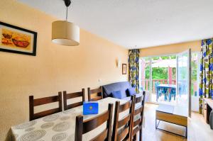 a dining room and living room with a table and chairs at Résidence Les Belles Rives - maeva Home - Appartement 2 pièces 6 personnes - Sélection MAE-2484 in Argentat