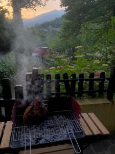 a grill with a piece of meat on it at Cutigliano con vista in Cutigliano