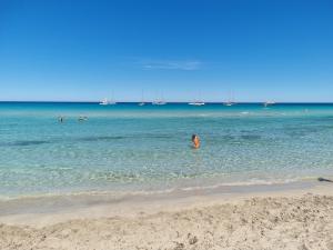 a person standing in the water at the beach at Il Tramonto Dorato in Carini