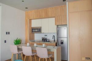 Η κουζίνα ή μικρή κουζίνα στο Hermoso y nuevo depto a pie de playa +9 φωτογραφίες