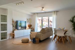 a living room with a couch and a table at Playa Granada Apartamentos Moriscos II in Motril