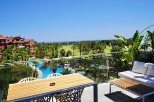 a balcony with a bench and a view of a pool at Playa Granada Apartamentos Moriscos II in Motril