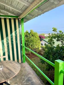 a balcony with a table and a view of the ocean at Chalet Ambel in Dhërmi