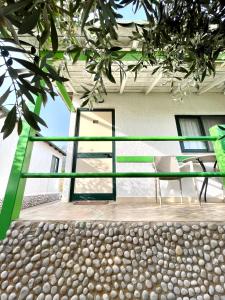 a balcony of a house with a table and chairs at Chalet Ambel in Dhërmi