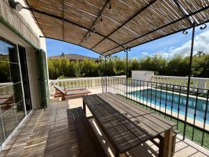 a patio with a swimming pool and a wooden pergola at Les Villas du Parc in Antibes