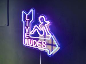 a neon sign for a nuesles sign on a wall at Big Group Stays in Brighton & Hove