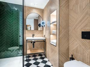 a bathroom with a sink and a shower at Doubletree By Hilton Nice Centre Iconic in Nice