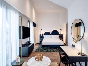 a hotel room with a bed and a mirror at Doubletree By Hilton Nice Centre Iconic in Nice