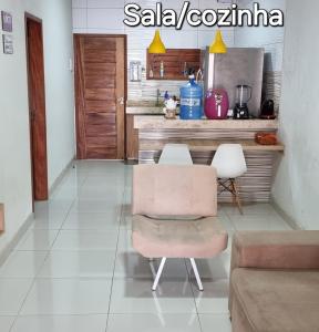 a living room with a table and a chair at Casa na praia com vista para o mar in Luis Correia