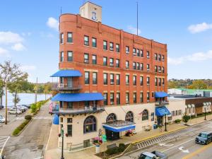 a large red brick building with a clock tower at Lafayette Hotel Marietta in Marietta