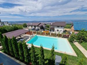 an aerial view of a house with a swimming pool at Panoramic Palace in Feleacu