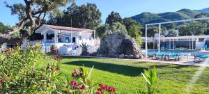 a house with a pool and a yard with flowers at AGRI ART in San Benedetto Ullano