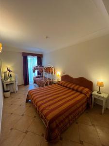 a bedroom with a bed and a chair in it at Hotel La Vue d'Or in Sorrento