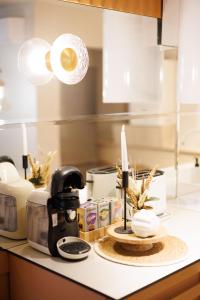 a kitchen counter with a candle on a table at Bear's Apartment Suite Alba Iulia in Alba Iulia