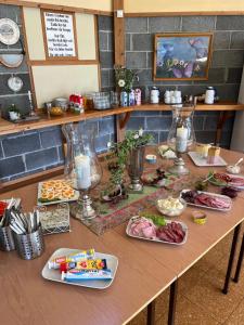 a table with many different types of food on it at Alværa Misionssenter Sommerhotel in Lavik
