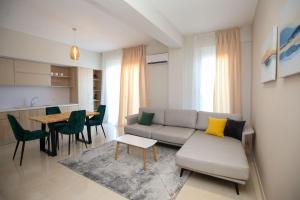 a living room with a couch and a table at Seaside Apartments in Vlorë