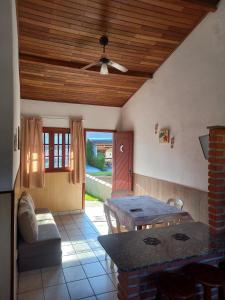 a living room with a table and a dining room at Chalés Luz Da Lua in Caraguatatuba