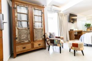 a room with a large wooden cabinet with windows at Hotel Terras da Finlândia in Penedo +51 photos