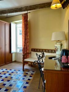 a living room with a couch and a table with a lamp at S.Andrea degli Armeni Dimora di Charme in Taranto