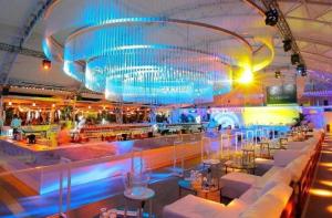a restaurant with a bar with white couches at Summerland Nikos Residence in Mamaia +19 photos