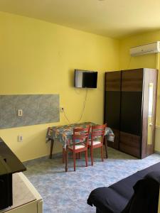 a dining room with a table and two chairs at Dejan apartment 3-Free parking near Arena in city center, near bus, train, ferry, airport shuttle in Pula