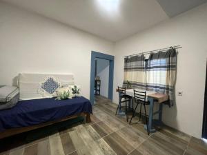a bedroom with a bed and a desk and a table at Casa de Huespedes Real 2 in San Pablo Villa de Mitla