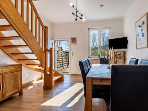 a living room with a dining room table and stairs at XXL Reihenhaus mit WLAN in Buchholz in Buchholz