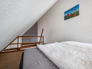 a bedroom with a bed and a picture on the wall at Studio in Buchholz am Müritzsee in Buchholz