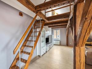 a staircase in a living room with wooden beams at Studio in Buchholz am Müritzsee in Buchholz