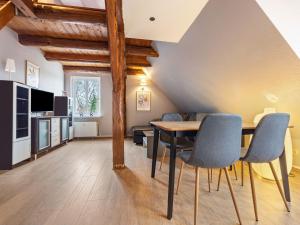 a living room with a dining room table and chairs at Ferienwohnung in Buchholz an der Müritz in Buchholz