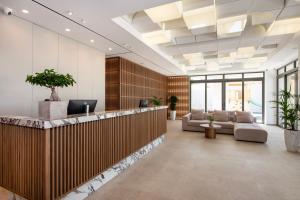 an office lobby with a reception desk and couches at Selini Suites & Waterpark in Kolymvari
