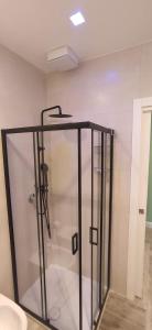 a shower with a glass door in a bathroom at Home trani in Trani +25 photos