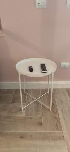 a white table with a remote control on top of it at Home trani in Trani