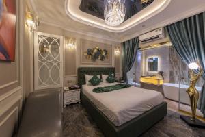a bedroom with a bed and a tub in a room at H A O Boutique Hotel in Ho Chi Minh City
