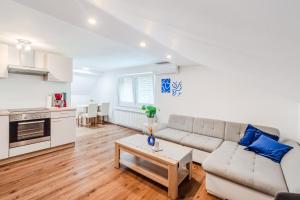 a living room with a couch and a table at Apartmaji Mouse in Bovec