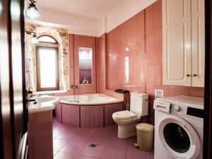 a bathroom with a tub and a toilet and a sink at Mansion 1887 in Limenas +68 photos