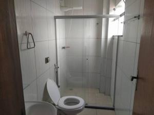 a bathroom with a shower with a toilet and a sink at Apartamento Encantador 201 in Vitória da Conquista +4 photos