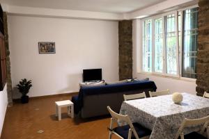 a living room with a couch and a table at A due passi dal mare in Portovenere